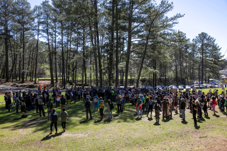 People protest against the building of an Atlanta public safety training facility during a Defend The Atlanta Forest march on the South River Trail in Atlanta