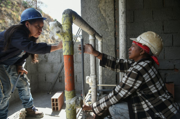 Claudia Tisoy (L) and Ursulina Guaramato are among the women executing the project in a country where construction is still widely seen as the domain of men