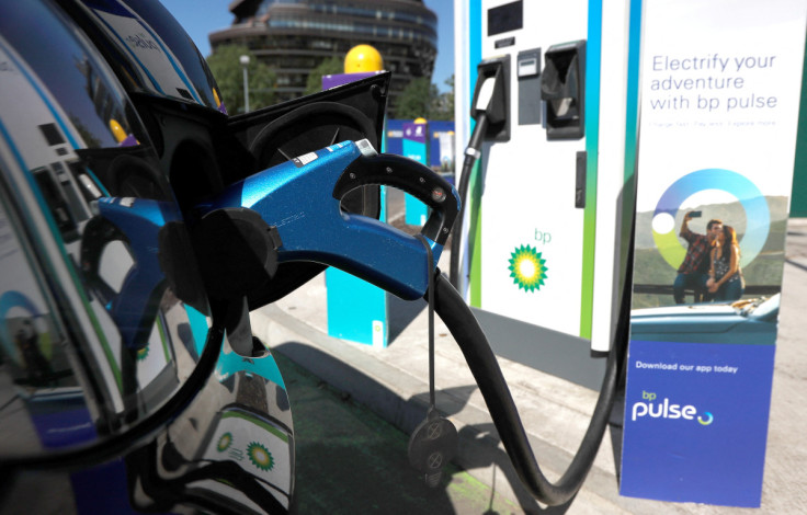 An electric powered taxi is seen being charged at a BP Pulse electric vehicle charging point in London