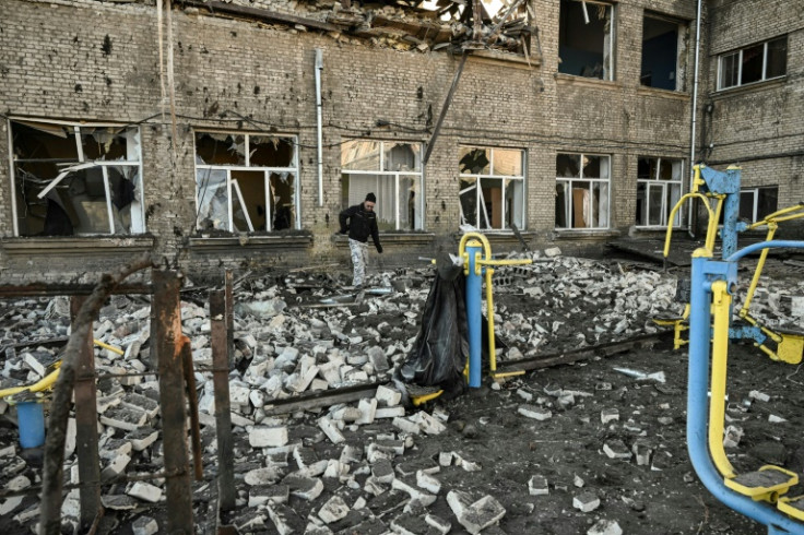A man walks outside a destroyed school after a missile strike in Kramatorsk in Ukraine's Donbas region