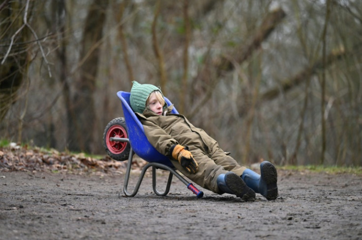 Living the dream: a young boy chills in a wheelbarrow at a forest school in Ballerup, Denmark