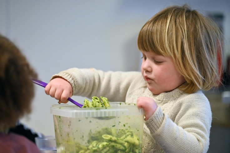 Independent: a young girl serves herself lunch at a Danish preschool