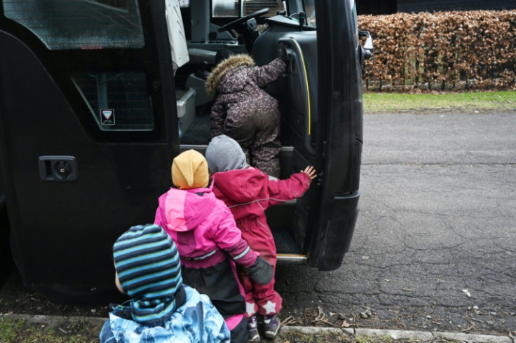 Preschool kids boarding a bus at their forest camp in Ballerup, Denmark