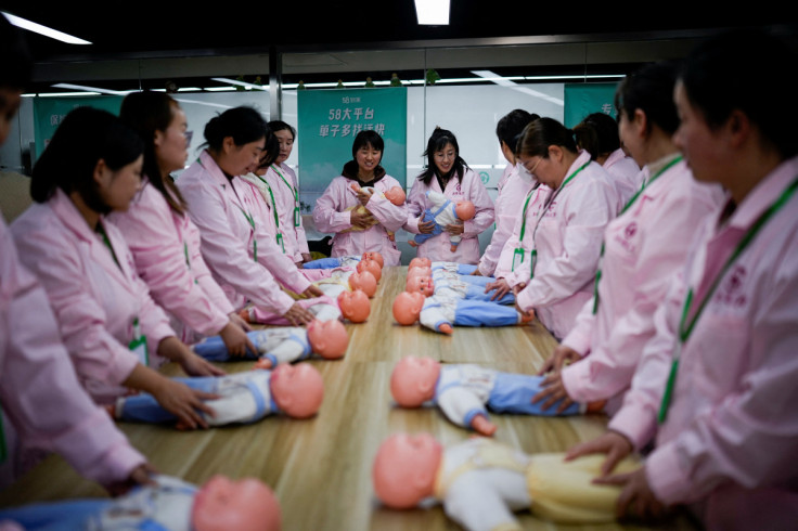 Women take part in a nursing skills class for confinement carers, in Shanghai