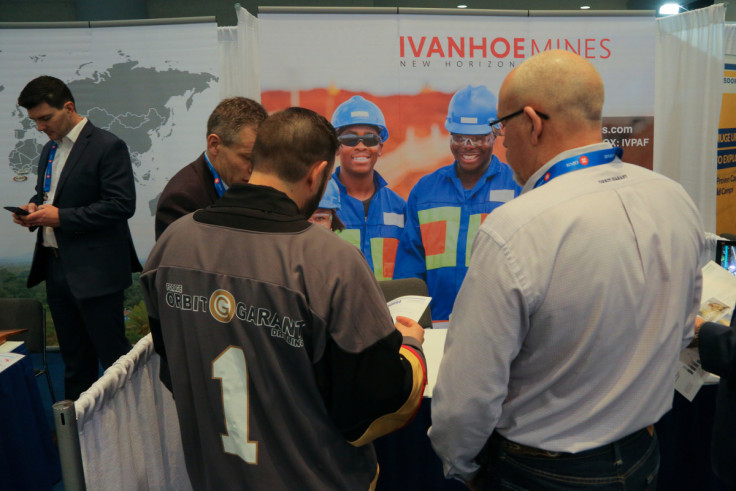 Visitors to the Ivanhoe Mines booth speak with a company representative during the PDAC convention in Toronto