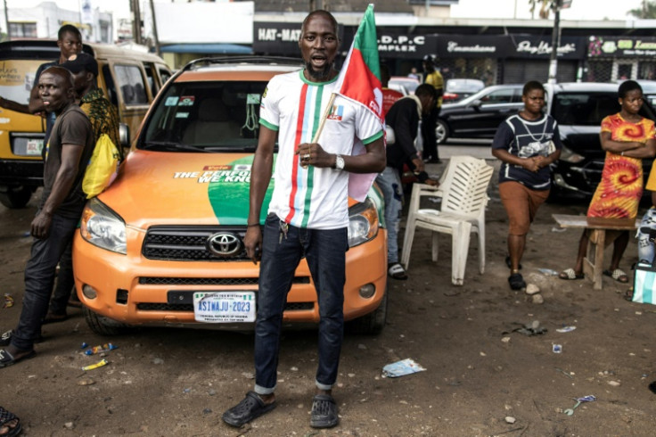 An APC supporter celebrates the victory of Bola Tinubu in Nigeria's highly disputed election