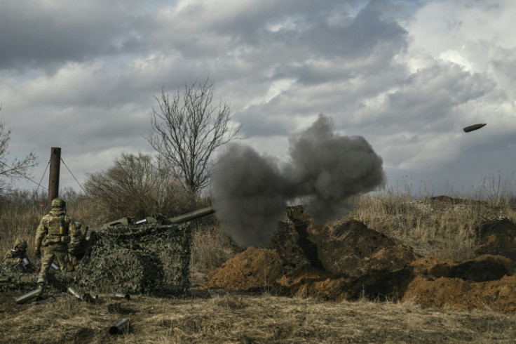 Ukrainian servicemen fire with a 105mm howitzer towards Russian positions near Bakhmut