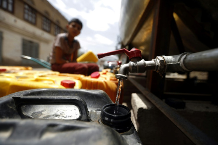 A Yemeni boy fills a jerrycan with safe drinking water from a donated water-tank in the capital Sanaa in 2017