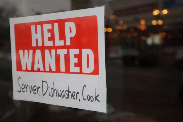 A “Help Wanted” sign hangs in restaurant window in Medford