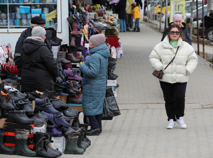 A woman walks through a local market in Comrat