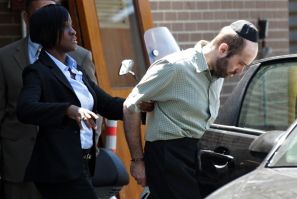 Murder suspect Levi Aron is escorted out of a New York Police Department precinct in Brooklyn
