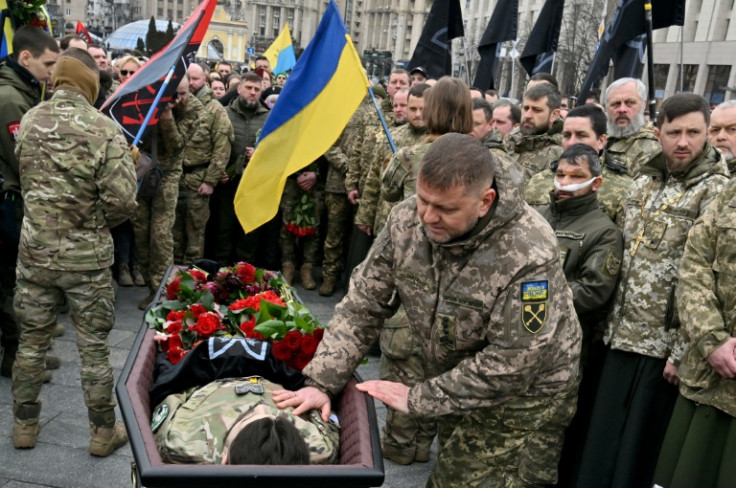 Ukraine's commander-in-chief Valery Zaluzhny kneels before Kotsiubailo's coffin