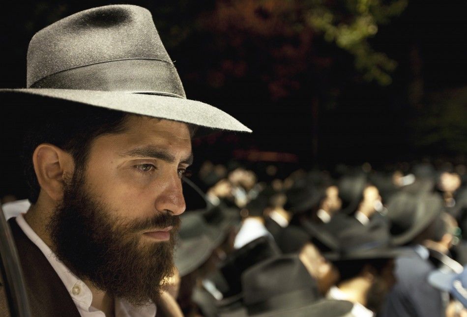A man listens to the funeral of Leibby Kletzky outside a synagogue in the Brooklyn borough of New York