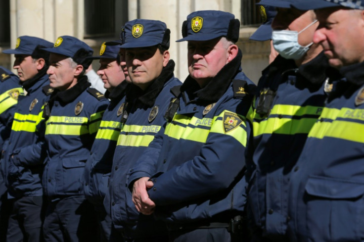 Georgian police keep watch anti-government protesters rallying outside parliament