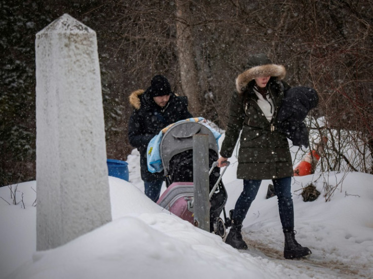 Bringing all their worldly possessions, migrants arrive in Canada through the Roxham Road border crossing