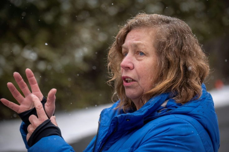 Frances Ravensbergen, spokesperson for the NGO Bridges Not Borders, hands out warm clothes to migrants headed to Canada