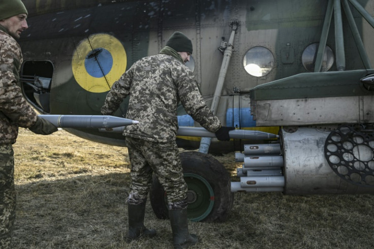 Ukrainian servicemen load rockets onto an  Mi-8 helicopter in the east of the country