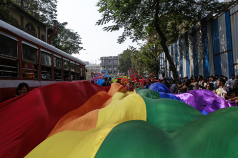 Participants hold a rainbow flag during gay pride parade, which is promoting gay, lesbian, bisexual and transgender rights, in Mumbai