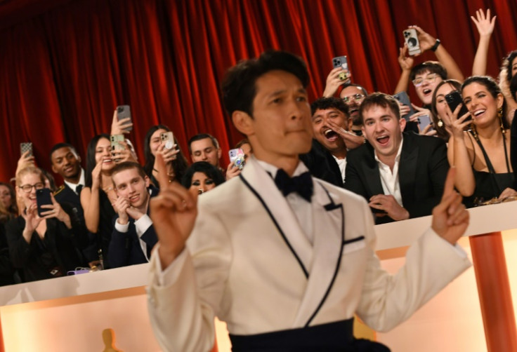 Attendees cheer as US actor Harry Shum Jr strutted up the Oscars red carpet