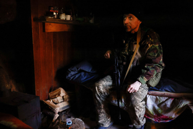 Ukrainian soldier listens to the sound of artillery