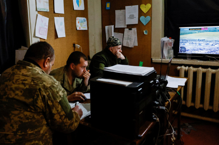 Ukrainian soldiers assist in directing operations from a command base near the frontline town of Kreminna