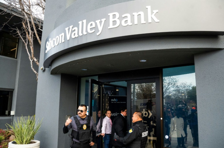 Security guards and FDIC representatives open a Silicon Valley Bank (SVB) branch for customers at SVB’s headquarters in Santa Clara, California, on March 13, 2023