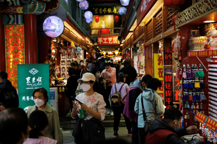 People visit a market at the tourism site of Qianmen street, in Beijing