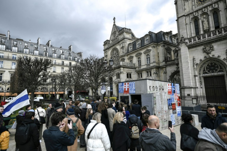 Visitors queue to look at a mock-up of the punishment cell of imprisoned Russian opposition politician Alexei Navalny in Paris
