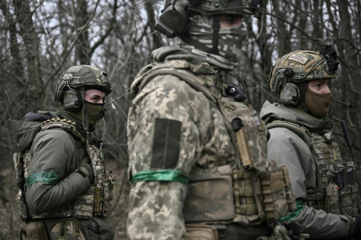 Members of the Ukrainian special unit stand in the woods near Bakhmut in eastern Ukraine