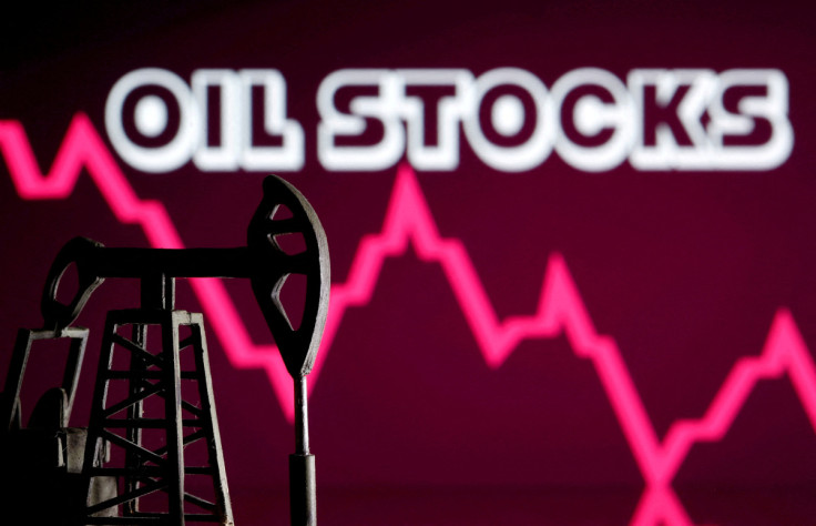 A 3D printed oil pump jack is seen in front of displayed stock graph and "Oil Stocks" words in this illustration picture