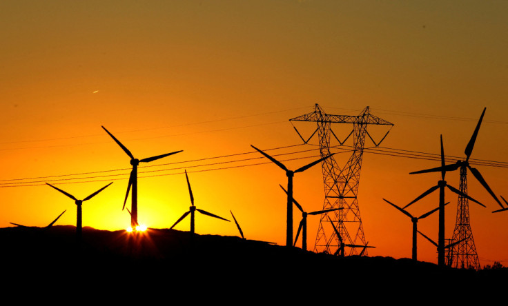 The sun rises behind windmills at a wind farm in Palm Springs