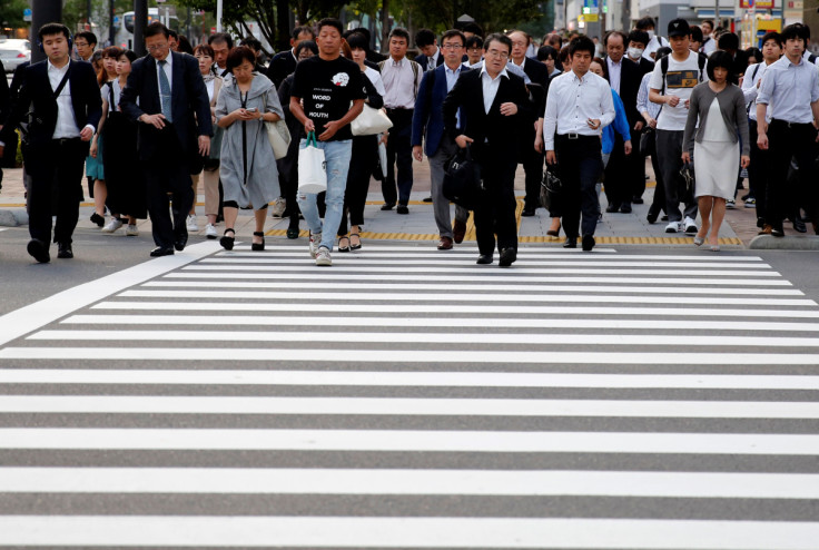 Pedestrians make their way in a business district in Tokyo