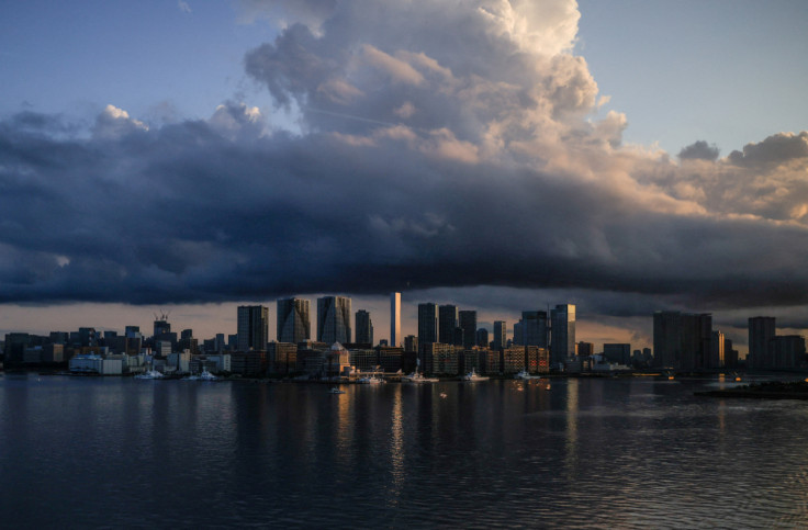 City skyline and harbour are seen at sunrise from a quarantine bus window during the Tokyo 2020 Olympic Games in Tokyo, Japan