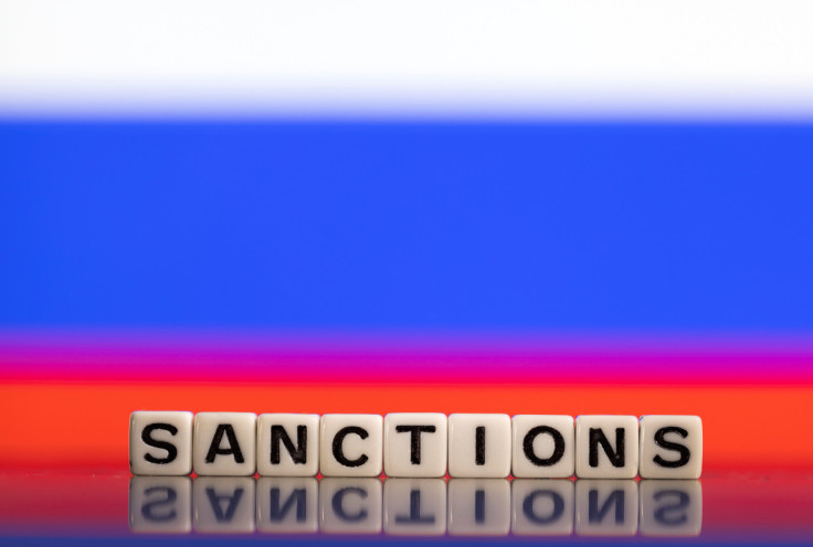 Illustration shows letters arranged to read "Sanctions" in front of Russian flag colors