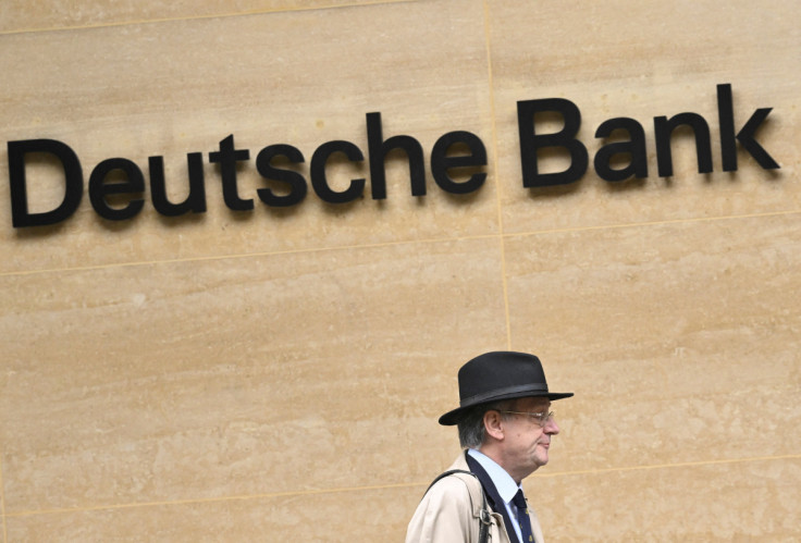 A worker walks past Deutsche Bank offices in London