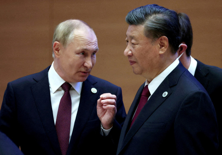 Russian President Vladimir Putin speaks with Chinese President Xi Jinping