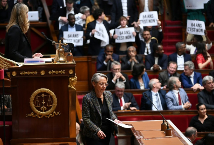 Prime Minister Elisabeth Borne (C) was booed in parliament on Thursday as she announced the pension reform would be rammed through