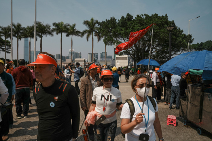 Travellers from Mainland China walk in the Golden Bauhinia Square, Hong Kong