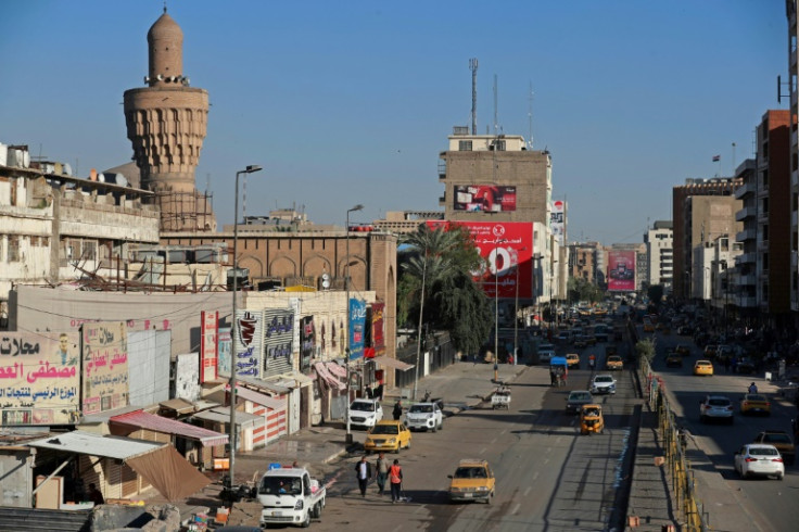 Vehicles drive along a street in Baghdad on March 19, 2023 -- a semblance of normalcy has returned