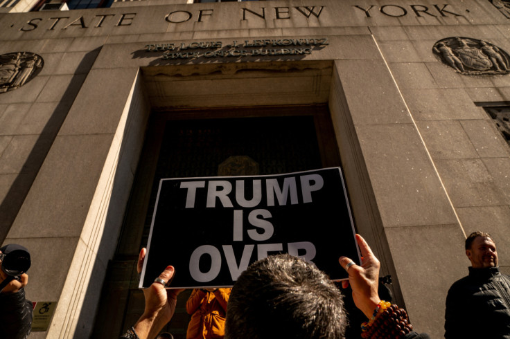 A protestor holds a sign outside 80 Centre Street, in New York City