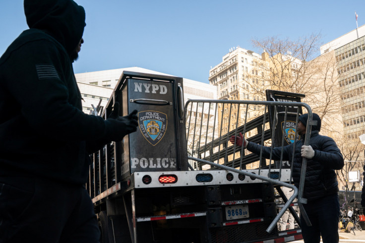 Police officers unload barricades outside Manhattan criminal court as Manhattan District Attorney Bragg continues his investigation into former U.S. President Trump