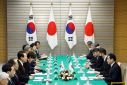 Japan's Prime Minister Fumio Kishida and South Korea's President Yoon Suk Yeol attend a meeting in Tokyo