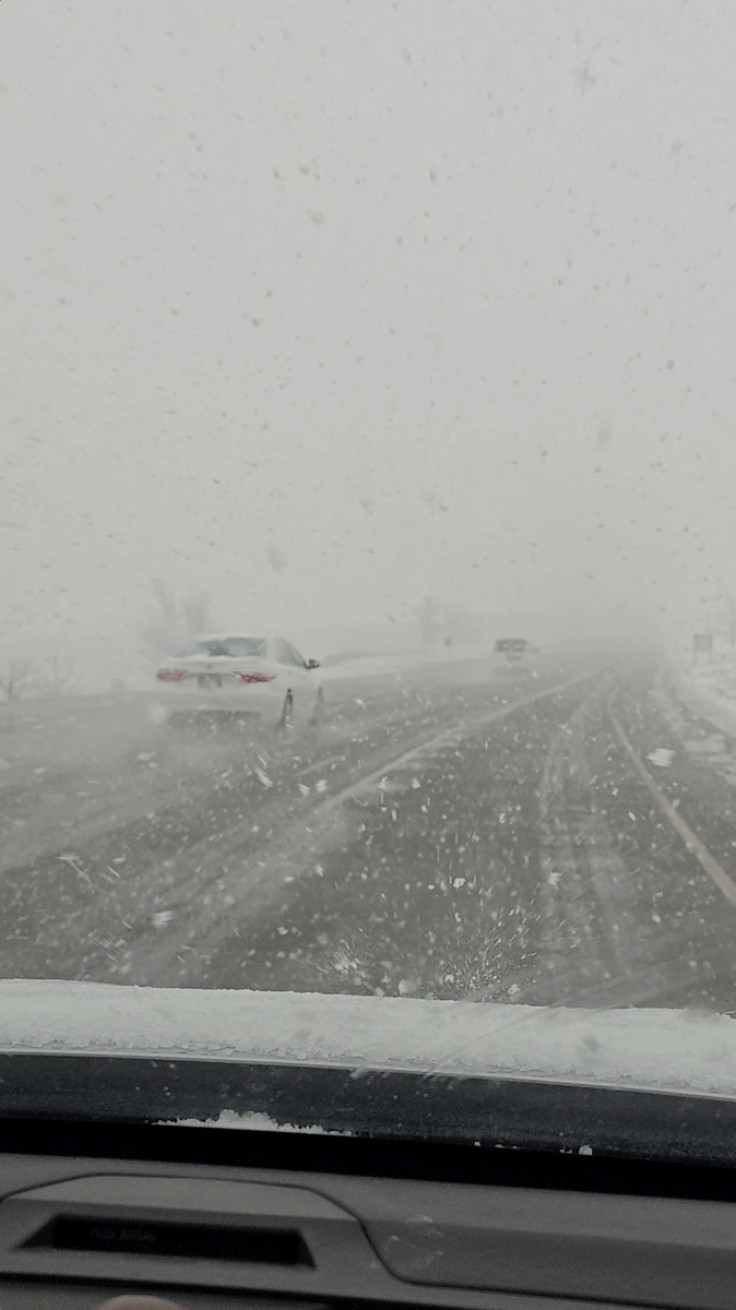 Vehicles drive during a snowstorm in Clearfield, Utah