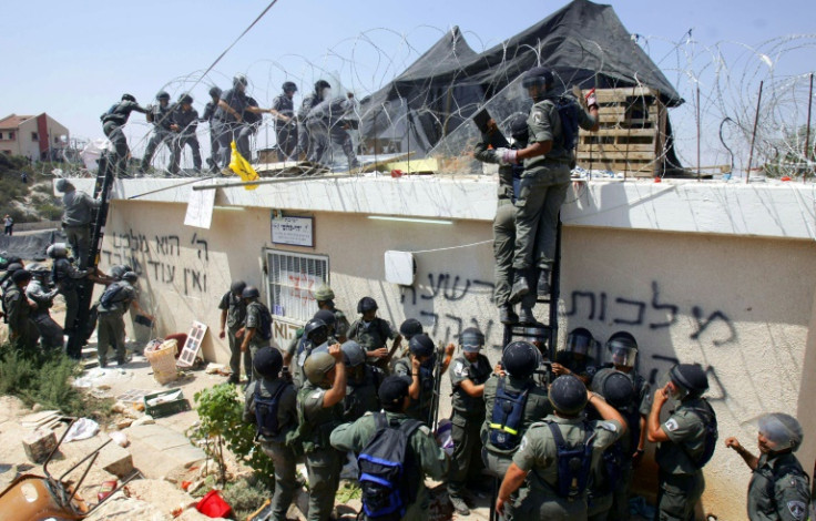 Israeli soldiers forcibly evict residents of the Jewish settlement of Homesh in 2005, one of four settlements evacuated alongide Israel's withdrawal from the Gaza Strip