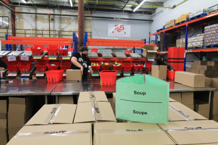 Volunteers fill boxes with donated food at the Ottawa Food Bank warehouse in Ottawa