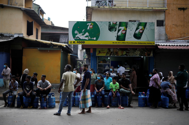People wait to buy domestic gas at a distribution centre, amid the country's economic crisis, in Colombo