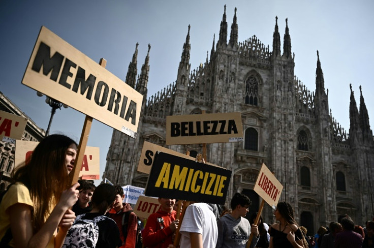 In the crowd gathered in the square infront of the Duomo were hundreds of relatives of victims, many of whom held aloft photos of their dead, and many of them still waiting for justice