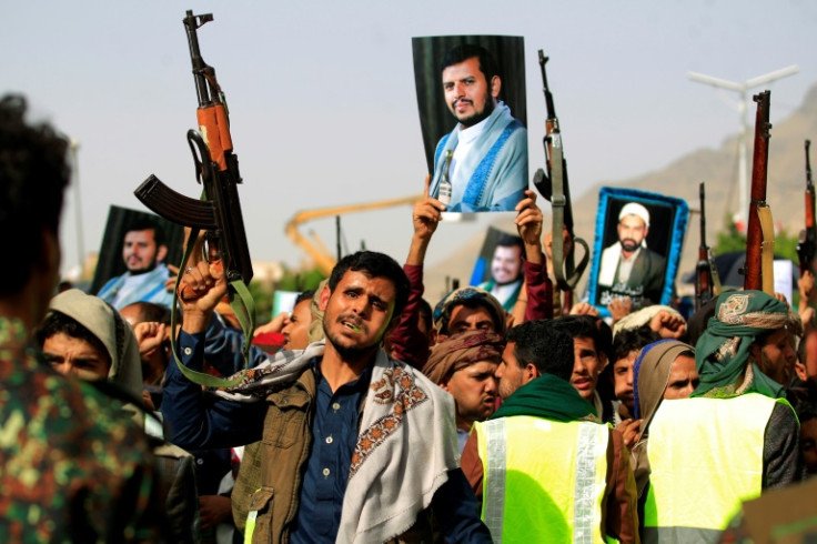 Supporters of Yemen's Huthi rebels raise portraits of their leader Abdul Malik al-Huthi in the capital Sanaa on June 3, 2022