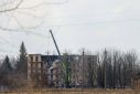 Rescuers work at a site of a building heavily damaged by Russian drone strikes, in Rzhyshchiv