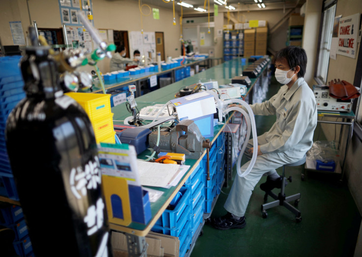 Employees of Sanko Manufacturing Co. are seen at the assemble line of the company's ventilators at the factory in Saitama